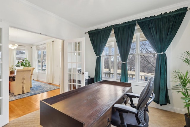 home office featuring crown molding, light hardwood / wood-style floors, and french doors