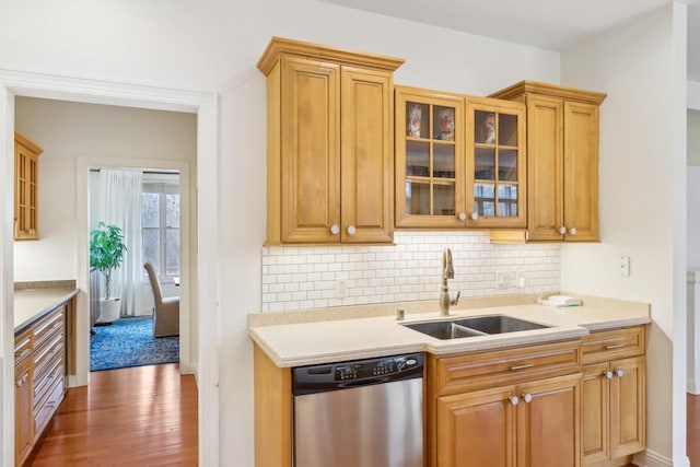 kitchen featuring tasteful backsplash, dishwasher, sink, and dark hardwood / wood-style flooring