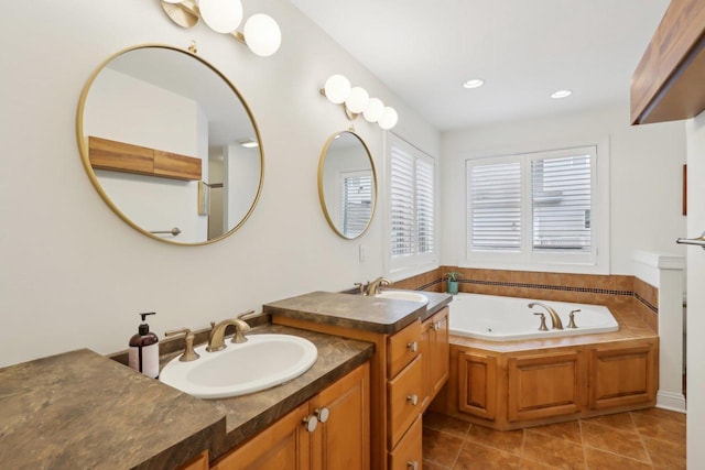 bathroom featuring vanity, tile patterned floors, and a tub to relax in