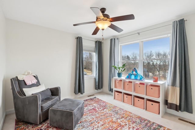 living area with ceiling fan