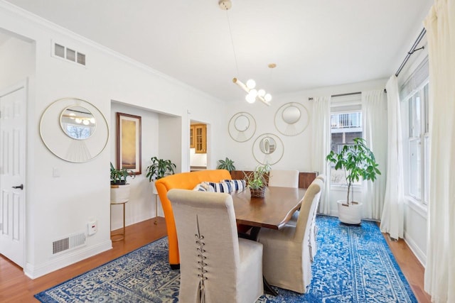 dining area featuring crown molding and wood-type flooring