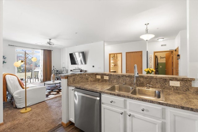 kitchen featuring dishwasher, sink, pendant lighting, and white cabinets