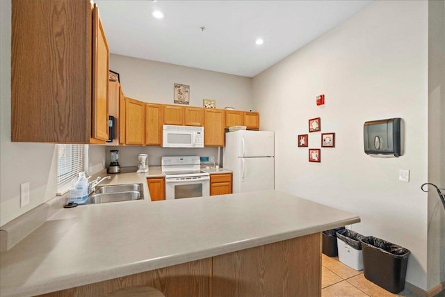 kitchen featuring sink, white appliances, kitchen peninsula, and light tile patterned floors