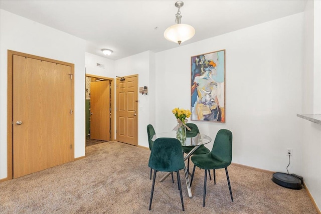 dining room featuring light carpet