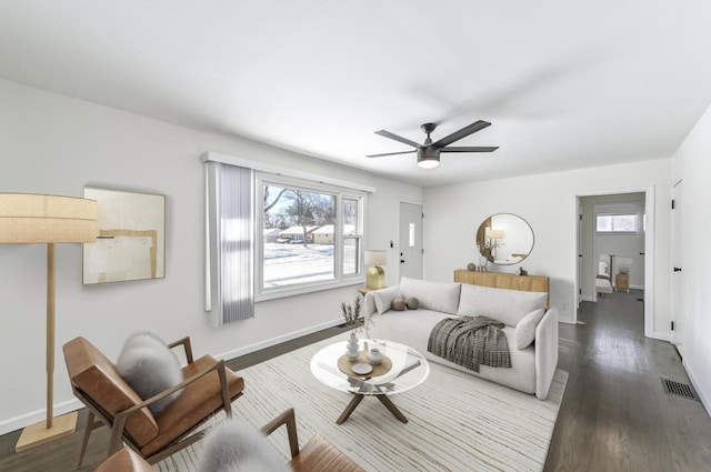 living room with ceiling fan and dark hardwood / wood-style floors