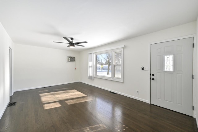 entryway featuring dark hardwood / wood-style flooring, an AC wall unit, and ceiling fan