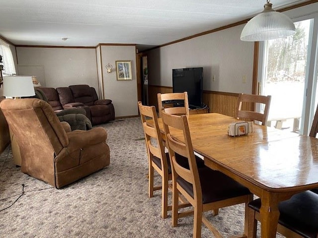 dining room with light colored carpet and ornamental molding