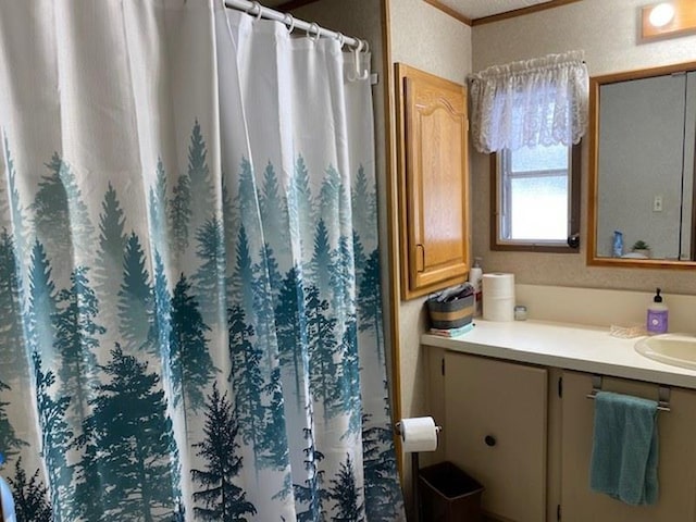 bathroom with vanity, crown molding, and a shower with curtain