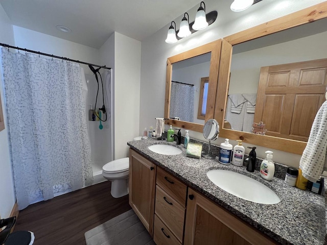 N8551 Lake Cabin Dr, New Lisbon, WI 53950 - bathroom featuring vanity, toilet, curtained shower, and hardwood / wood-style floors