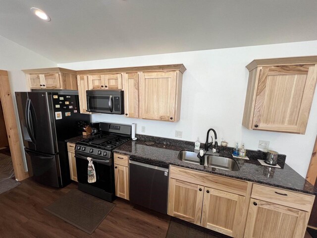 N8551 Lake Cabin Dr, New Lisbon, WI 53950 - kitchen with dark stone countertops, dark hardwood / wood-style flooring, sink, and black appliances