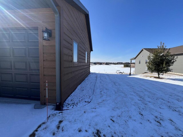 N8551 Lake Cabin Dr, New Lisbon, WI 53950 - view of snow covered exterior with a garage