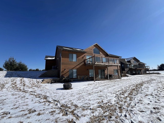 N8551 Lake Cabin Dr, New Lisbon, WI 53950 - snow covered back of property with a deck and an outdoor fire pit