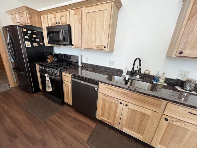 N8551 Lake Cabin Dr, New Lisbon, WI 53950 - kitchen with sink, dark stone countertops, light brown cabinets, dark hardwood / wood-style flooring, and black appliances