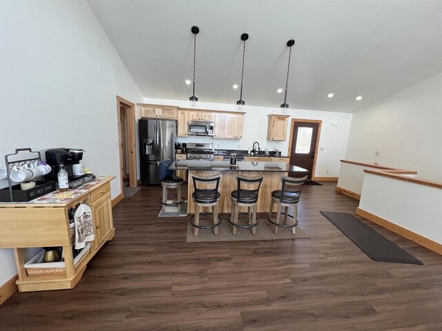 N8551 Lake Cabin Dr, New Lisbon, WI 53950 - kitchen featuring a kitchen bar, light brown cabinetry, a center island, appliances with stainless steel finishes, and pendant lighting