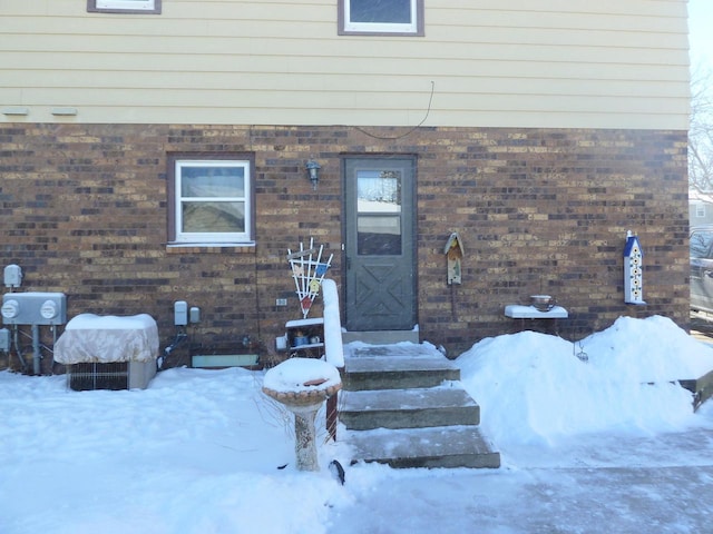 view of snow covered property entrance