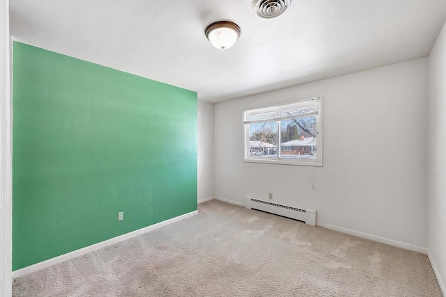 carpeted spare room with a baseboard radiator