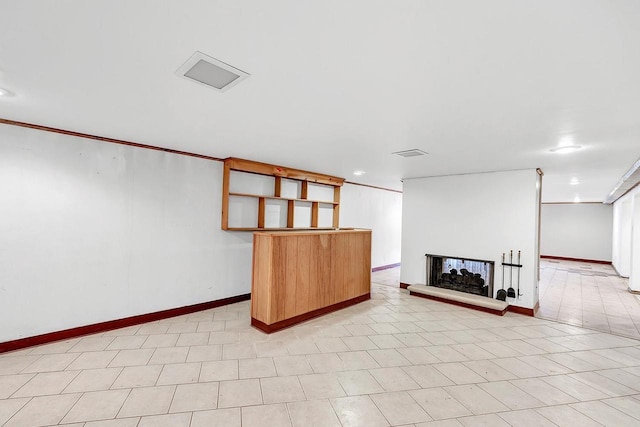 interior space with a multi sided fireplace and crown molding