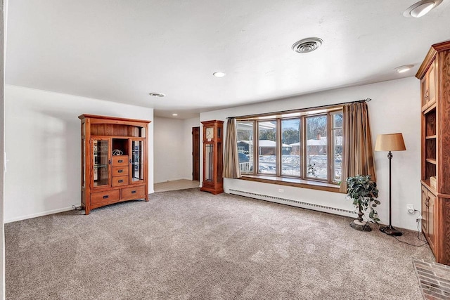 unfurnished living room featuring carpet flooring and baseboard heating