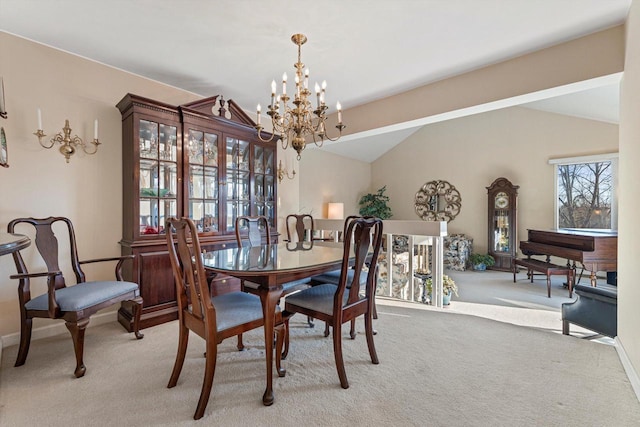 carpeted dining room featuring an inviting chandelier and vaulted ceiling