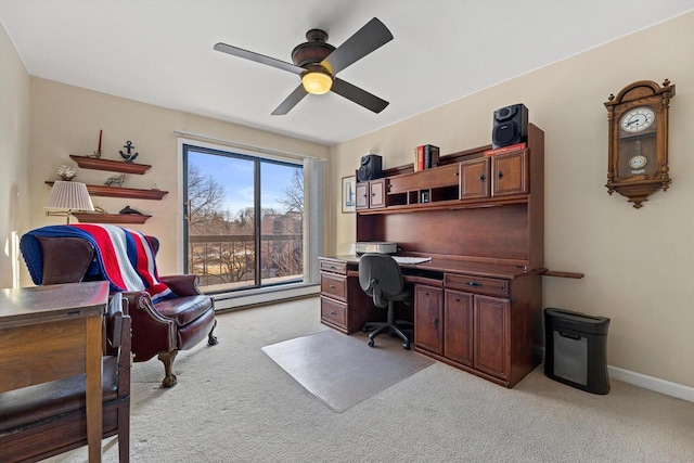 carpeted office space featuring ceiling fan and baseboard heating