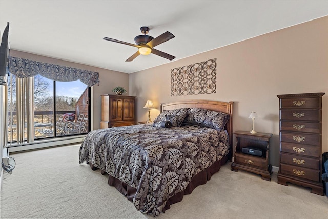 bedroom with ceiling fan and light carpet