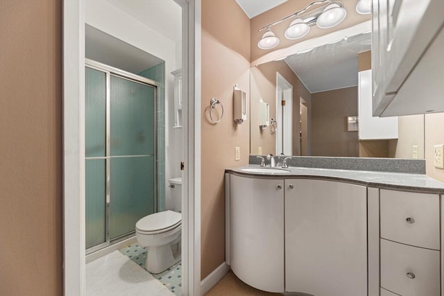 bathroom with vanity, toilet, and walk in shower