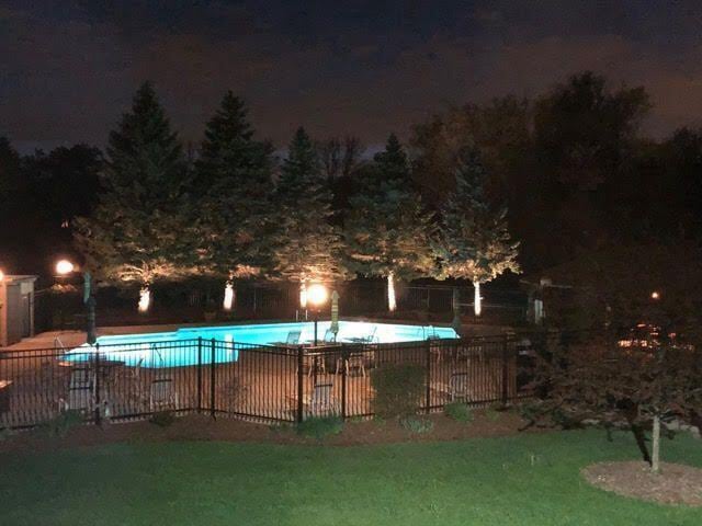 pool at twilight featuring a lawn