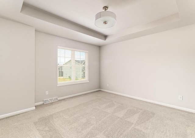 6542 Prairie Wood Dr, Mcfarland, WI 53558 - carpeted empty room with a raised ceiling and baseboards