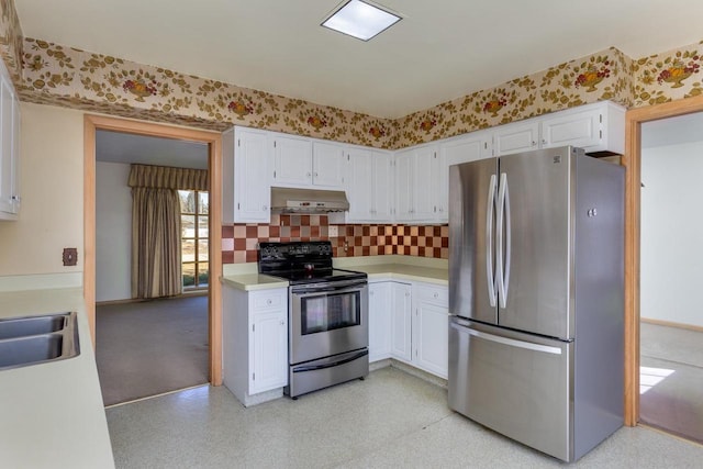 kitchen featuring under cabinet range hood, white cabinets, light countertops, appliances with stainless steel finishes, and wallpapered walls