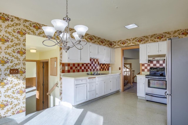 kitchen featuring wallpapered walls, under cabinet range hood, stainless steel appliances, and light countertops