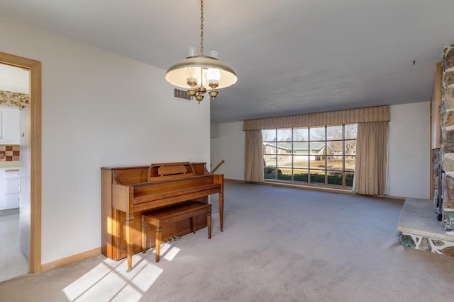 sitting room featuring baseboards, visible vents, a notable chandelier, and carpet flooring