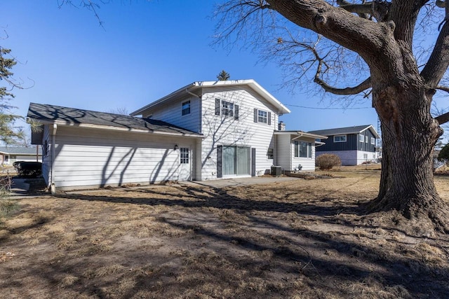 back of house with central AC unit