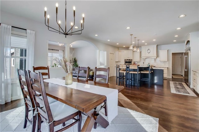 dining space featuring hardwood / wood-style flooring and decorative columns