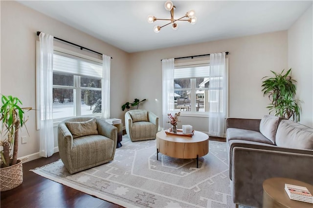 sitting room with wood-type flooring and a chandelier