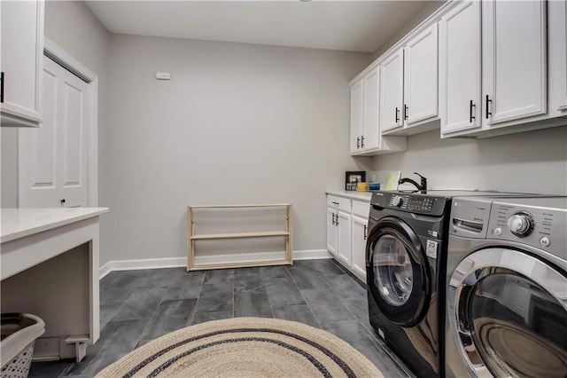 clothes washing area featuring cabinets and independent washer and dryer