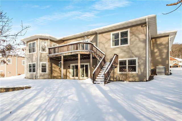 snow covered property featuring a wooden deck