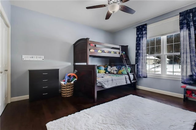 bedroom with dark hardwood / wood-style flooring and ceiling fan