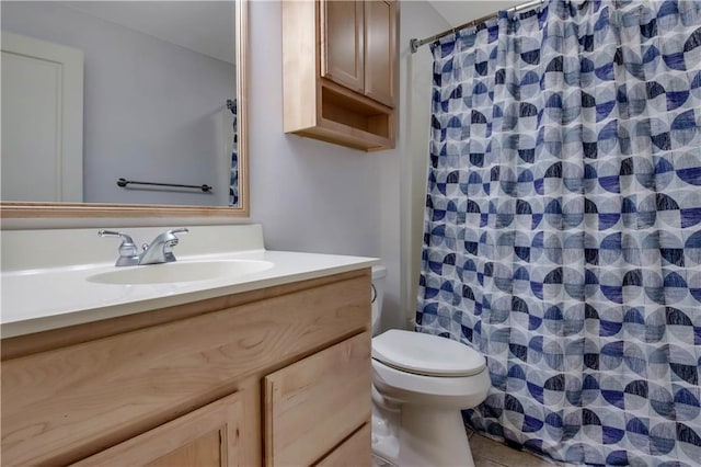 bathroom featuring tile patterned flooring, vanity, a shower with shower curtain, and toilet