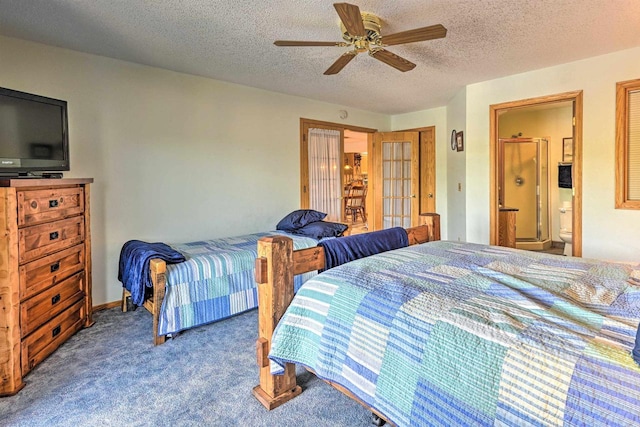 carpeted bedroom featuring ceiling fan, ensuite bathroom, and a textured ceiling