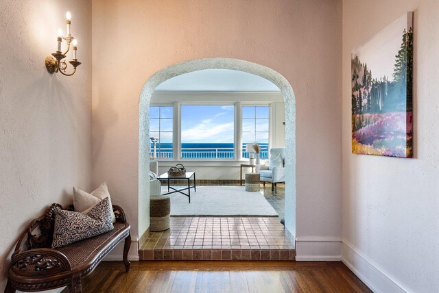 interior space with hardwood / wood-style flooring and a water view