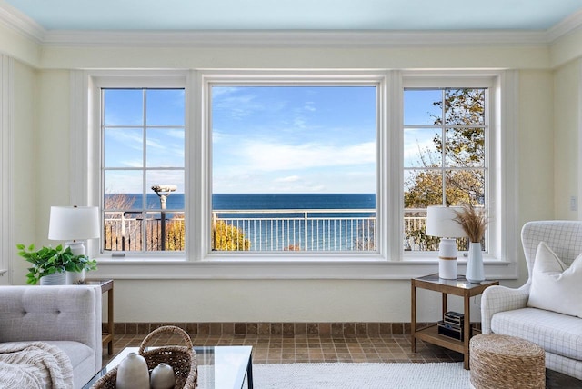 living area with crown molding and a water view