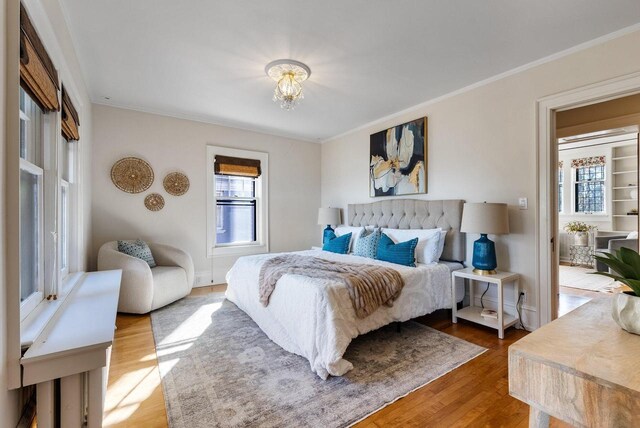 bedroom featuring hardwood / wood-style flooring and crown molding