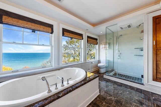 bathroom with a water view, plus walk in shower, and toilet