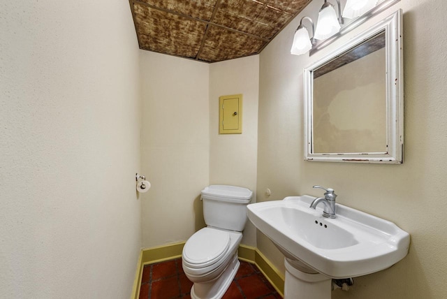 bathroom with tile patterned flooring, sink, and toilet