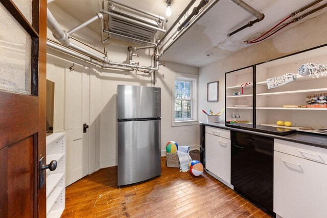 kitchen with hardwood / wood-style flooring, stainless steel refrigerator, and dishwasher