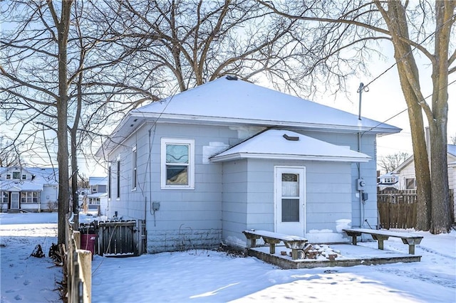 view of snow covered rear of property