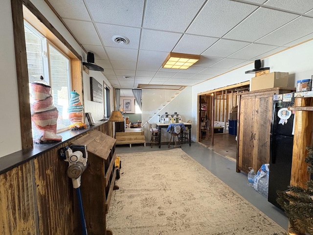 interior space with a paneled ceiling