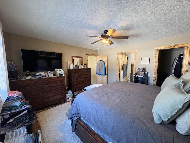 bedroom with a textured ceiling and ceiling fan