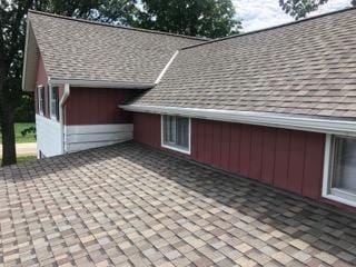 view of property exterior with a shingled roof