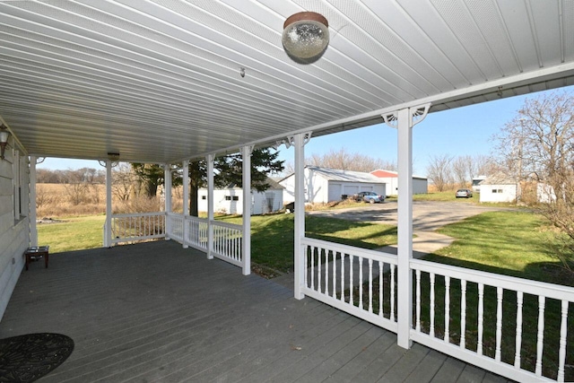 wooden deck featuring a lawn